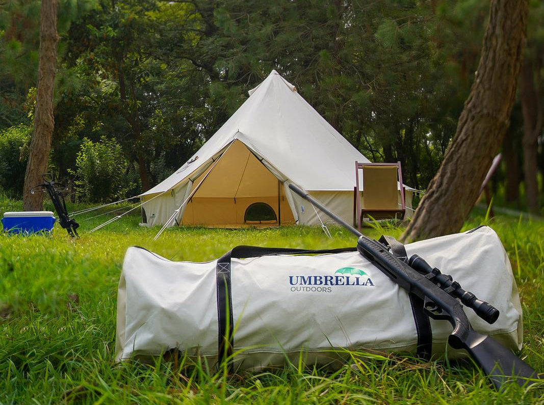 Camping tent with an umbrella in a forest setting